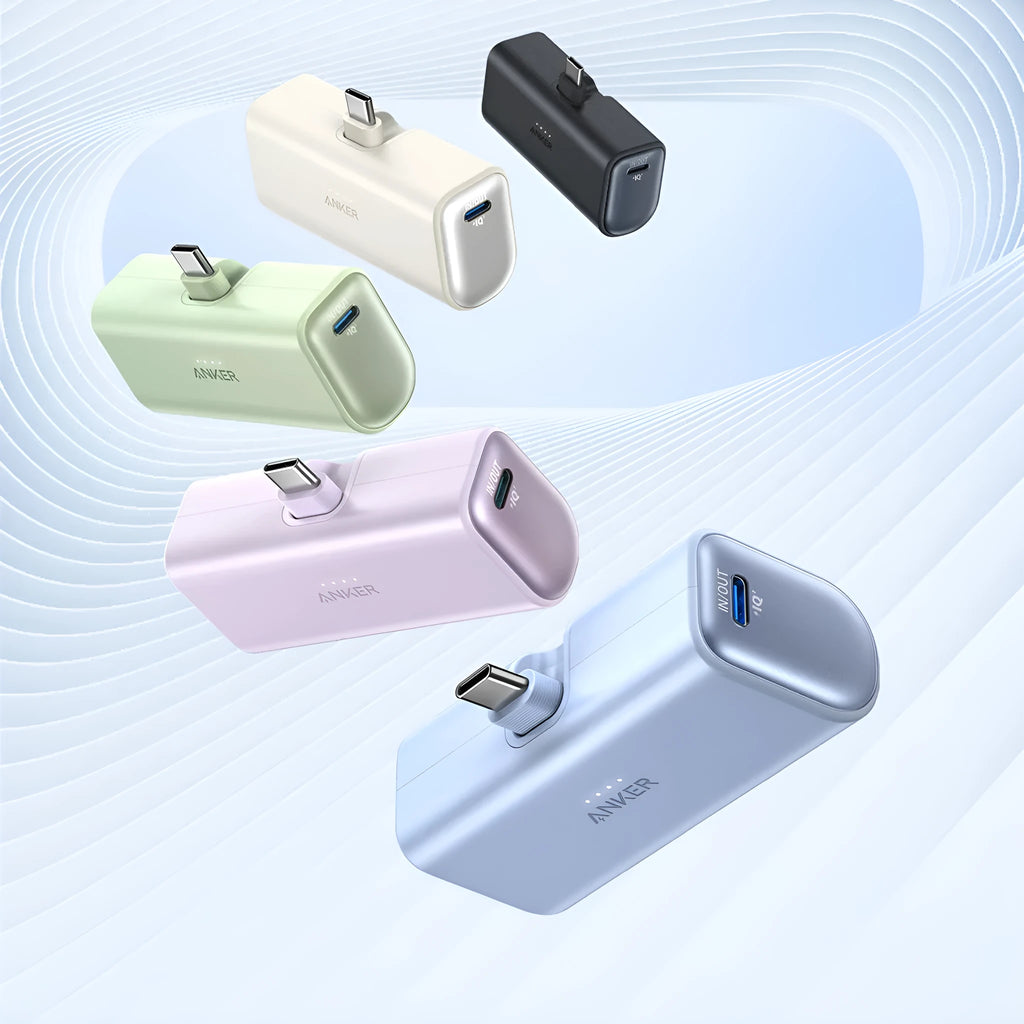 Small black capsule-shaped power bank with a foldable USB-C cable next to it