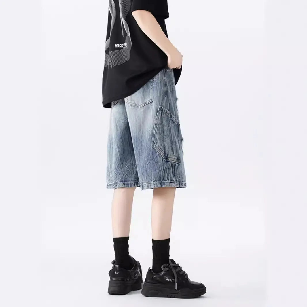Women's distressed denim shorts with ripped detailing and washed vintage finish in loose retro fit