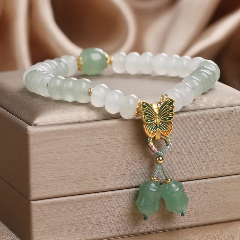 Green crystal women's bracelet with abacus beads, butterfly charm and tassel showing 17cm adjustable purity