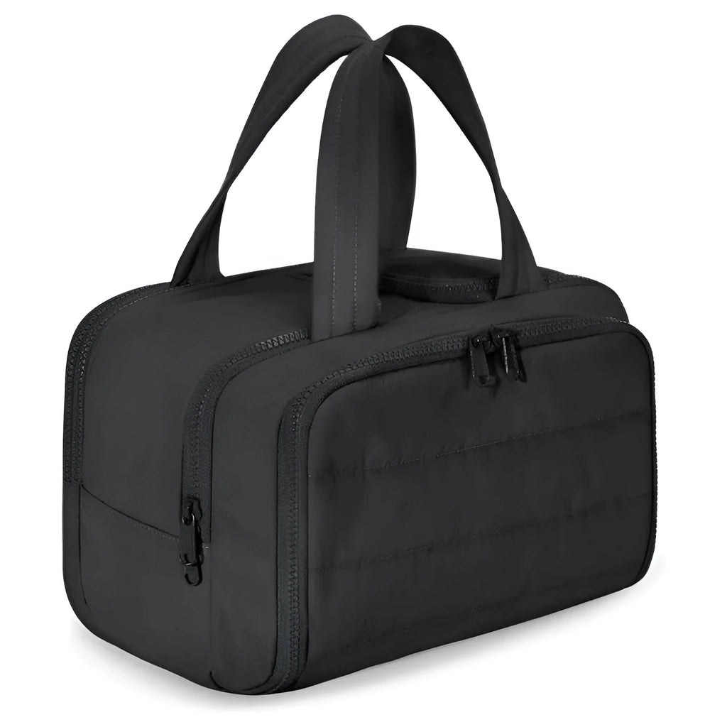 Large beige travel toiletry bag with wide open top, shown next to cosmetic bottles.