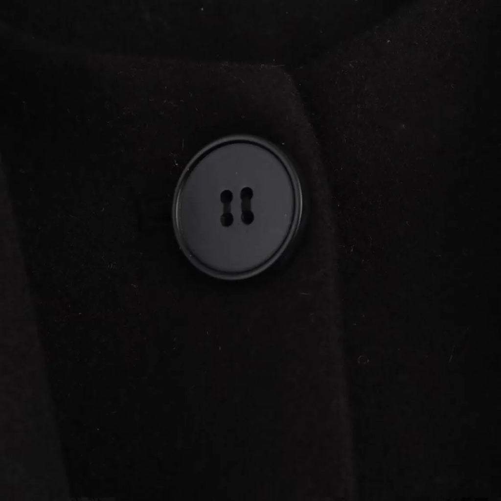 Women's long black overcoat with an artificial fur collar, shown with side pockets.