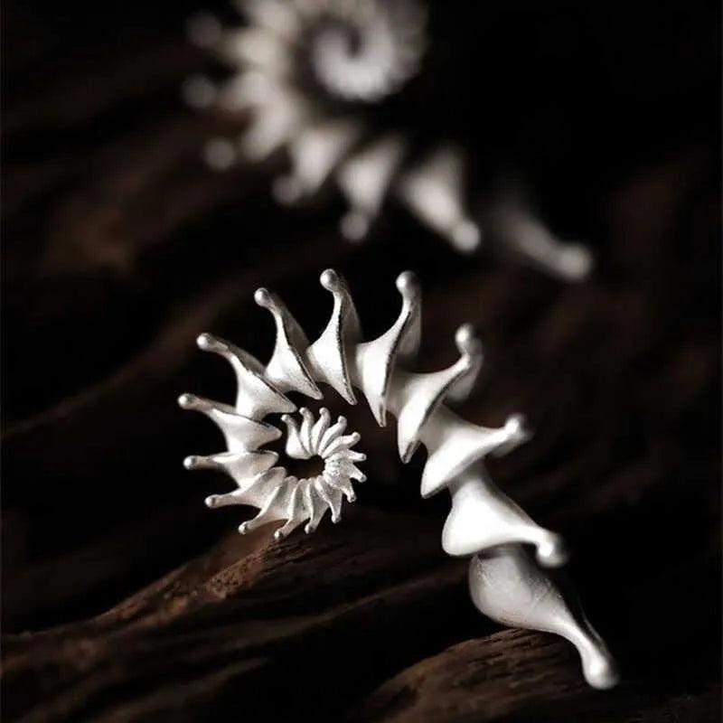 Three-dimensional matte finish conch stud earrings with exaggerated shape and irregular design elements