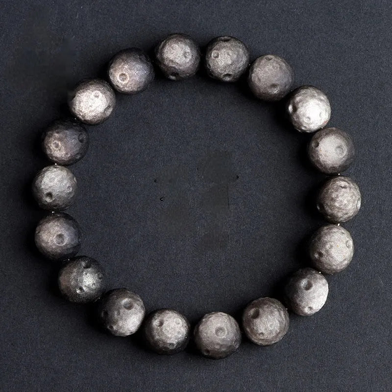 Obsidian crater ball bracelet with grinding texture in silver or golden meteorite colours
