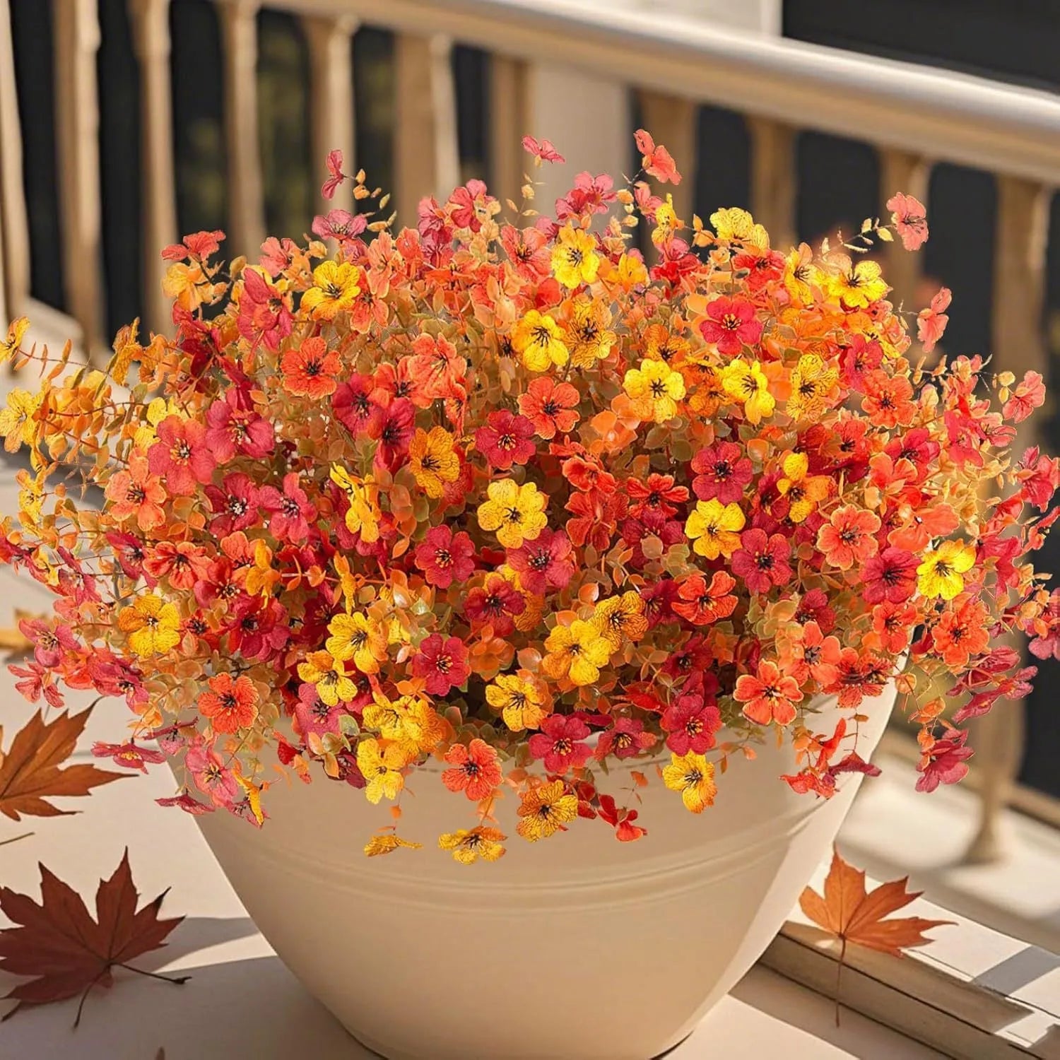 Artificial flower bouquet in autumn colours including orange, yellow, and red tones