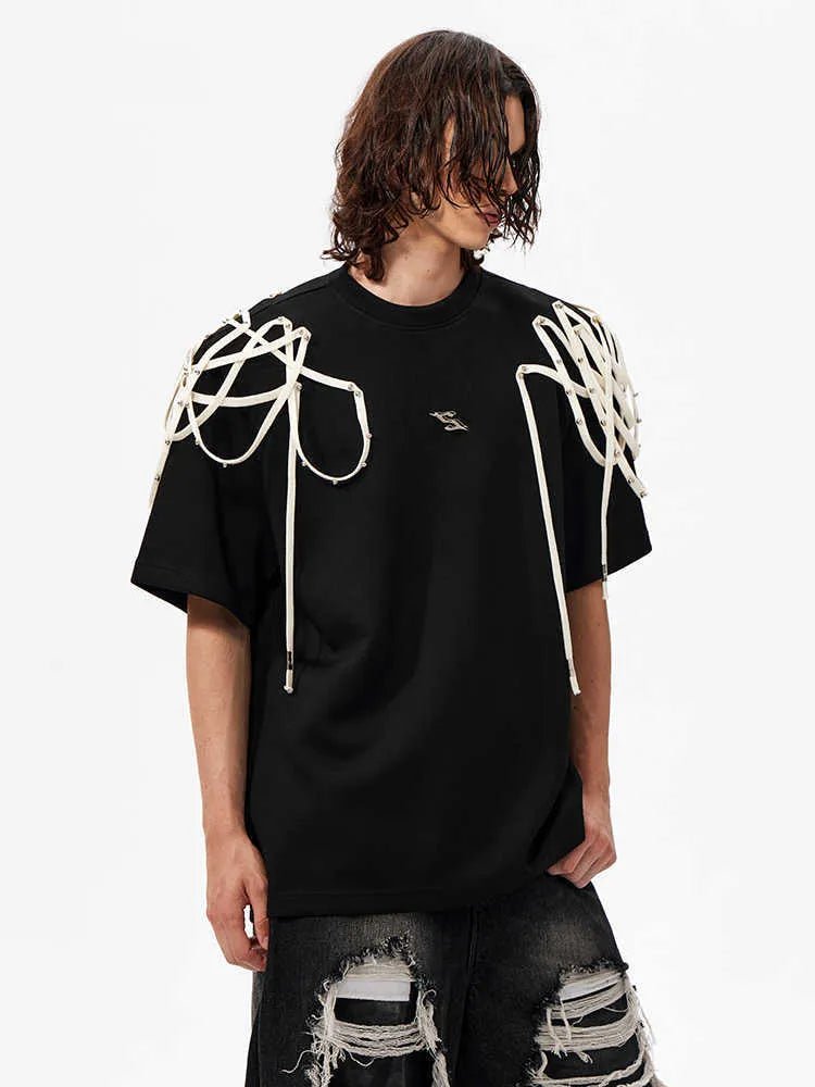 Black loose-fit short-sleeved t-shirt showing padded shoulder detail with rivet ribbon.