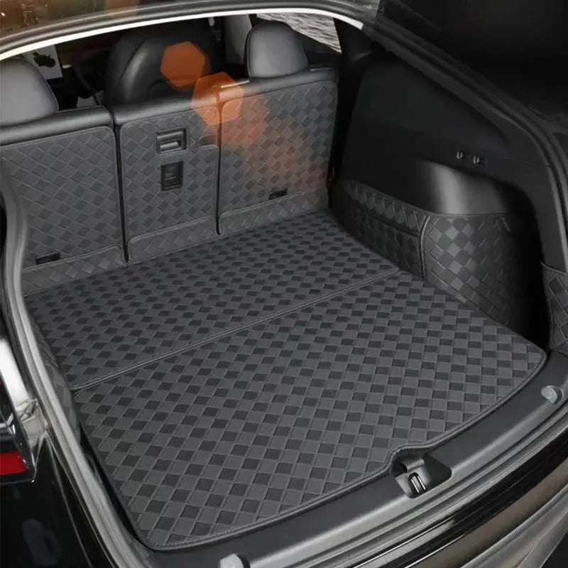 Black leather boot liner mat fitted in the luggage compartment of a Tesla Model Y
