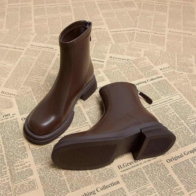 Women's black ankle boots with thick flat heels and back zipper fastening