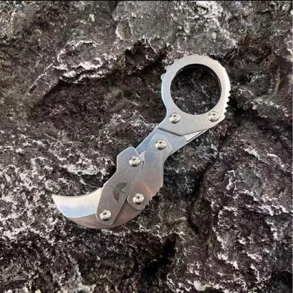 Small stainless steel 420J2 folding knife with 2.6cm blade on table