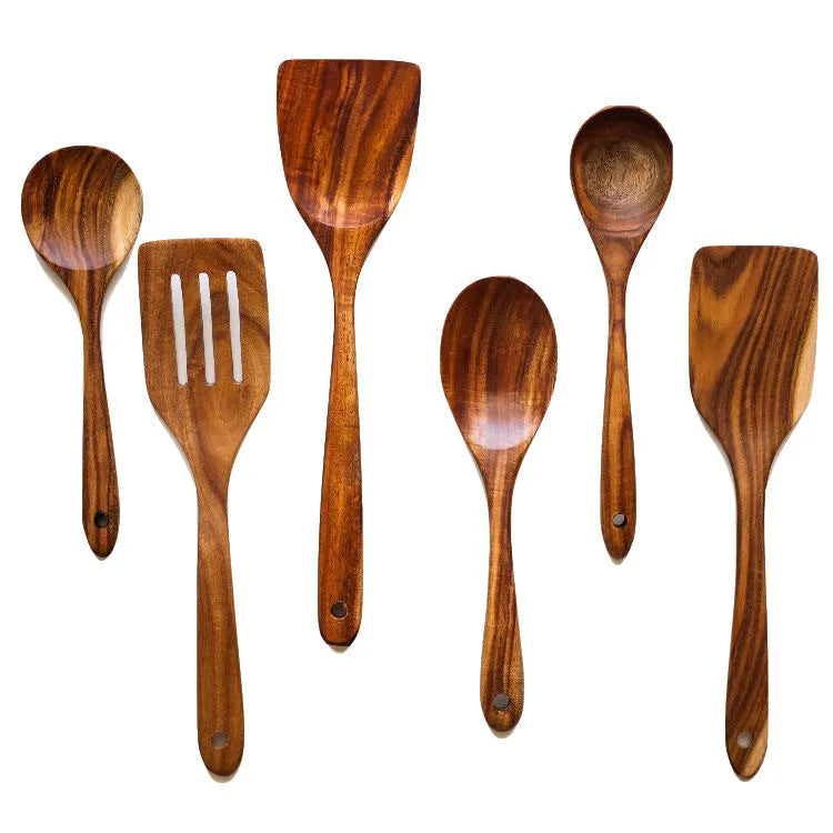 Set of 7 wooden cooking utensils including spoons and shovels arranged on a kitchen surface