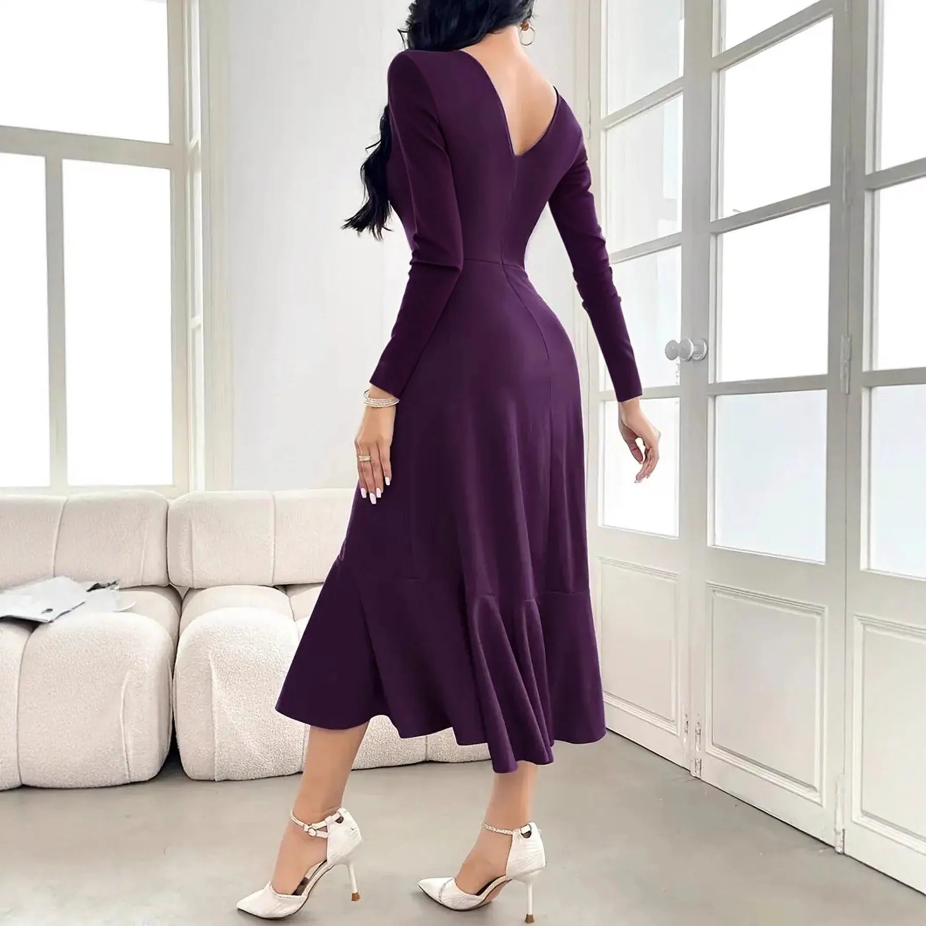 Purple women's long sleeve dress with ruffles and mid waist design on hanger