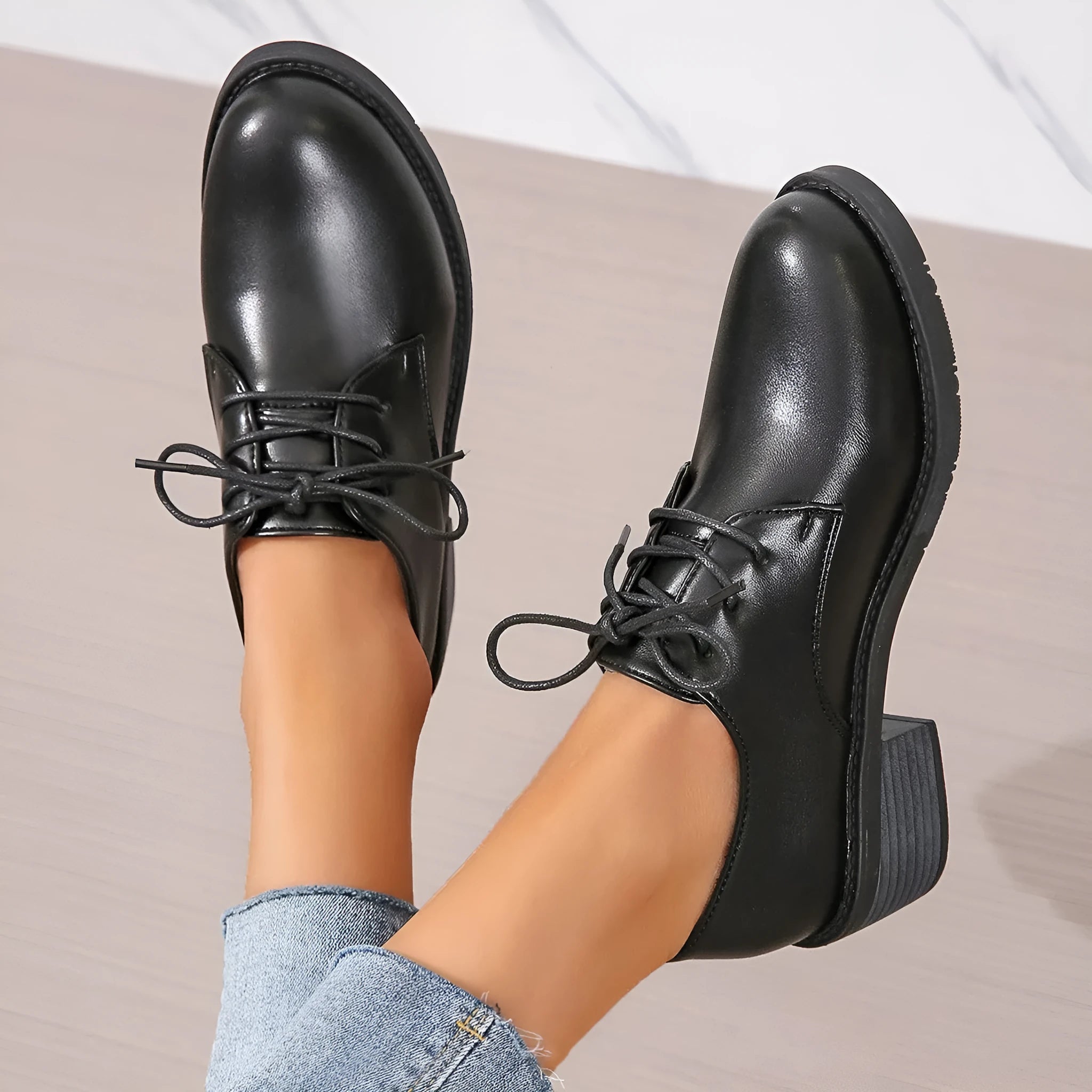 Black women's lace-up work shoes with a thick chunky heel and soft rubber sole.