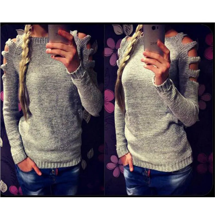 Women's white hollow-out crocheted knit long sleeve pullover shirt on a hanger.
