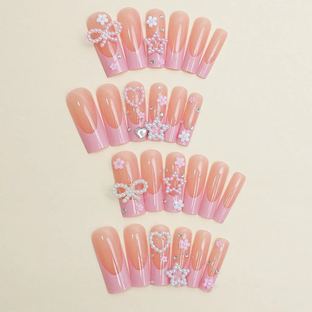 Close-up of a love pattern bow nail decoration in colour XB-70-48 on a nail.
