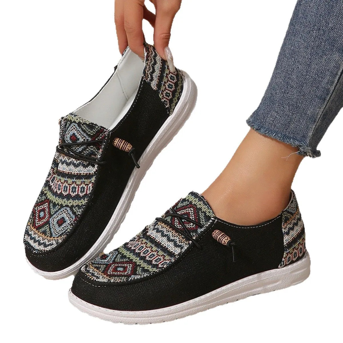 Women's low-top flat slip-on shoes in black, dark grey, or khaki with a round toe and rubber sole.