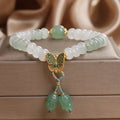 Green crystal women's bracelet with abacus beads, butterfly charm and tassel showing 17cm adjustable purity