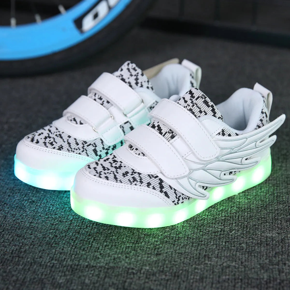 Child wearing plum red USB-rechargeable LED light up sneakers with colourful flashing lights.
