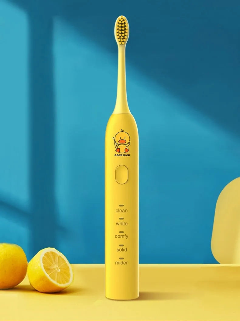 Rechargeable electric toothbrush with small yellow duck design, soft bristles, and USB charging cable