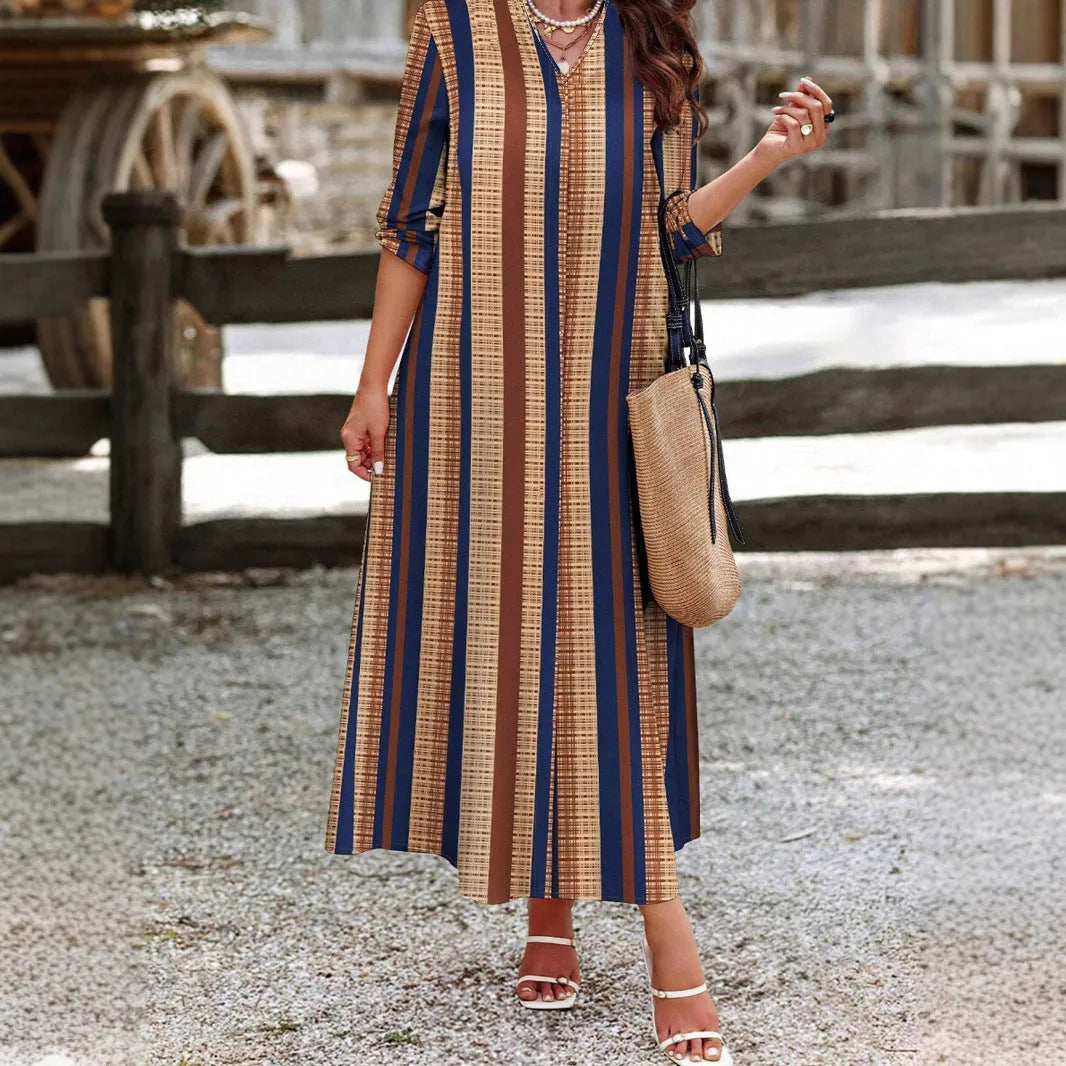 Camel coloured striped V-neck long sleeve knit dress with an A-line skirt on a hanger.