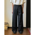 Men's straight-leg wide trousers in black, showing casual suit pant style with draping fabric.