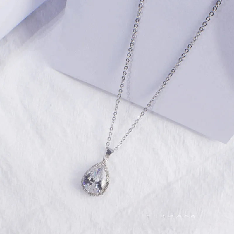 Rose gold electroplated necklace with water drop shaped geometric pendant and rhinestone detailing