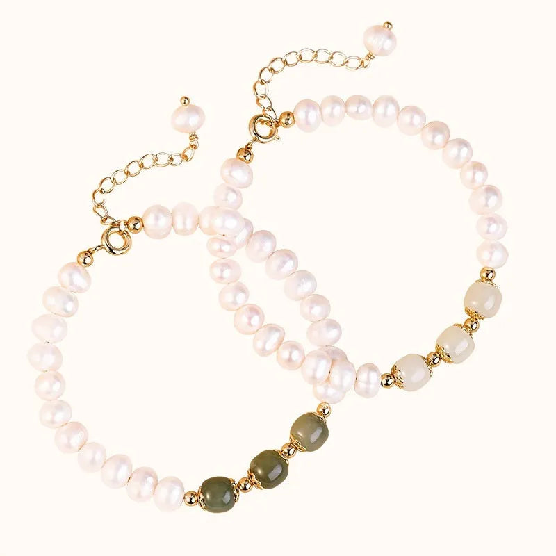 Close-up of a diamond-shaped freshwater pearl bracelet in an electroplated Hetian jade colour on a wrist.