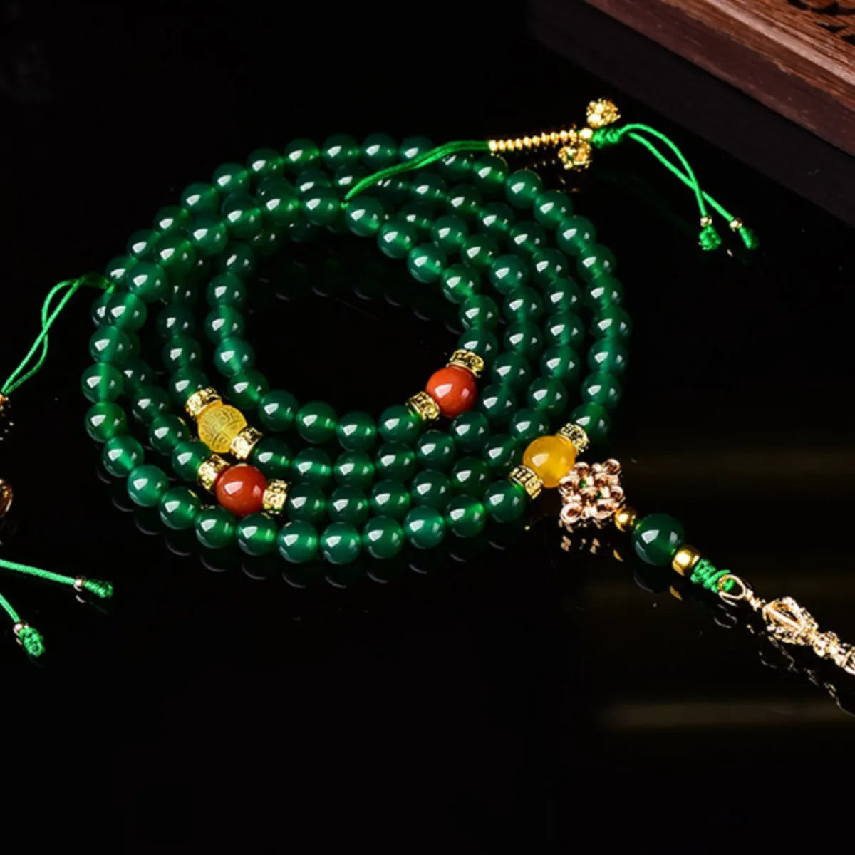 Close-up of a multi-circle green agate bracelet for men and women on a wrist.