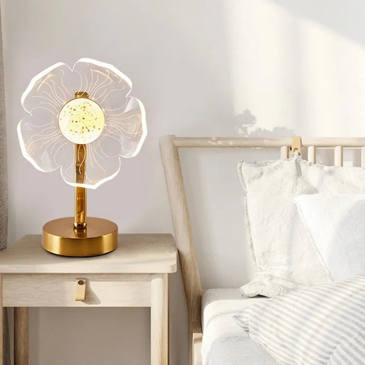Creative acrylic table lamp with three-colour USB dimming, sunflower shape, on a desk