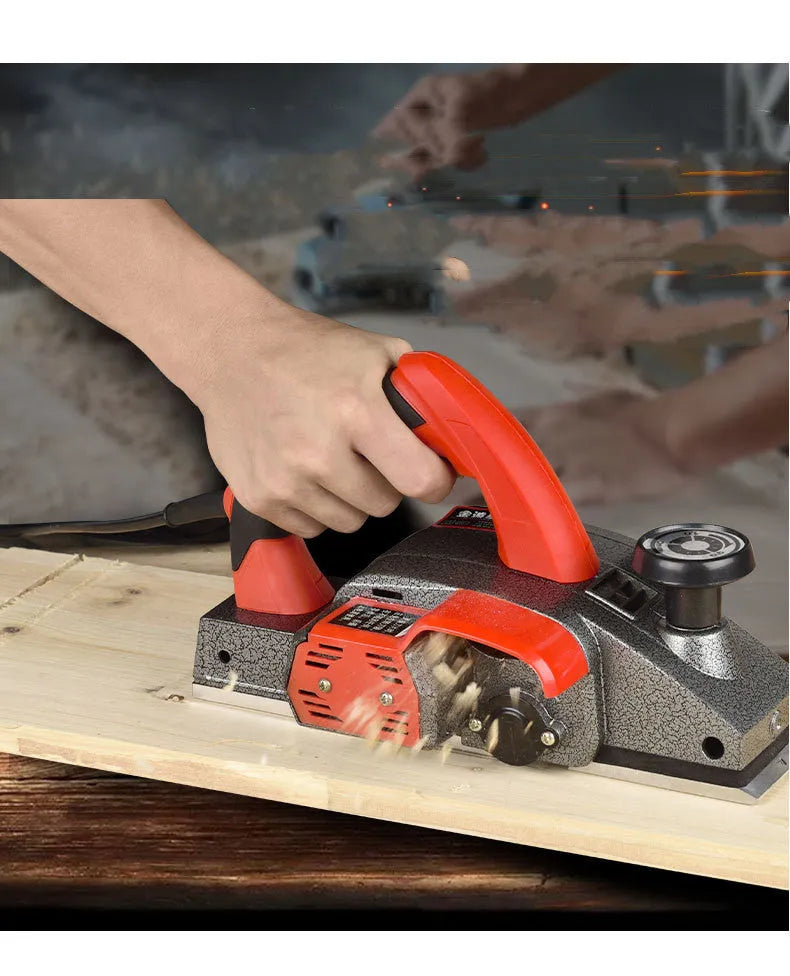 Red electric wood planer with 82mm cutting width and aluminium shell construction