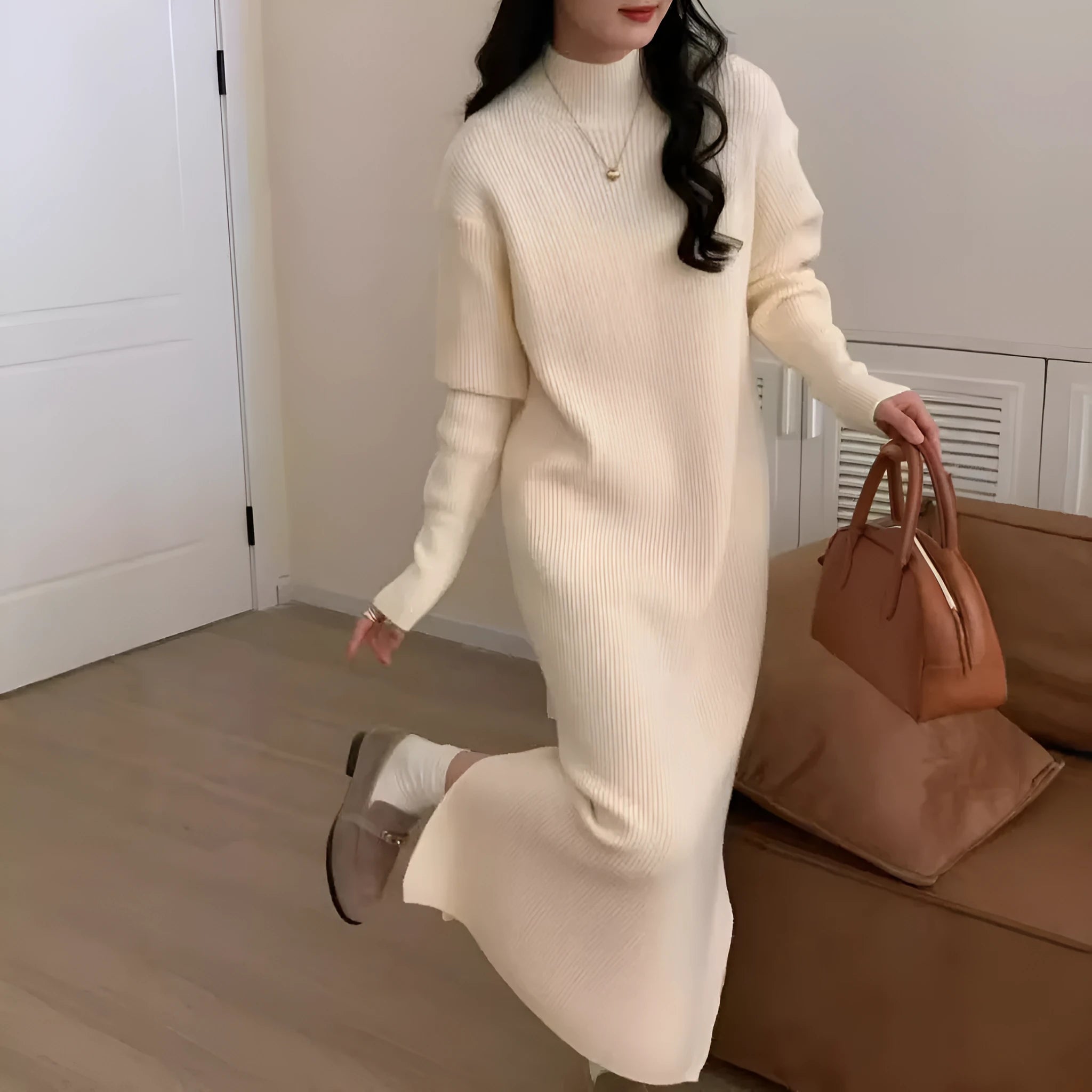 Half turtleneck knitted dress in a solid colour on a model, showing high waist and midi length.