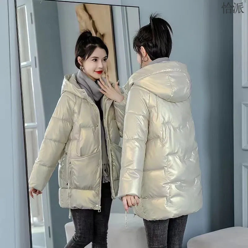 A loose-fitting, hooded winter jacket for women in a thick acrylic blend fabric, shown on a hanger.