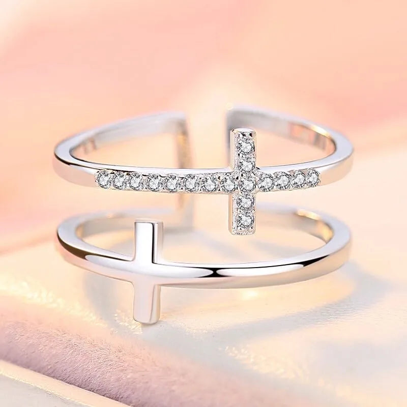 Adjustable double cross geometric ring in white gold colour with sterling silver and zircon gem inlay.