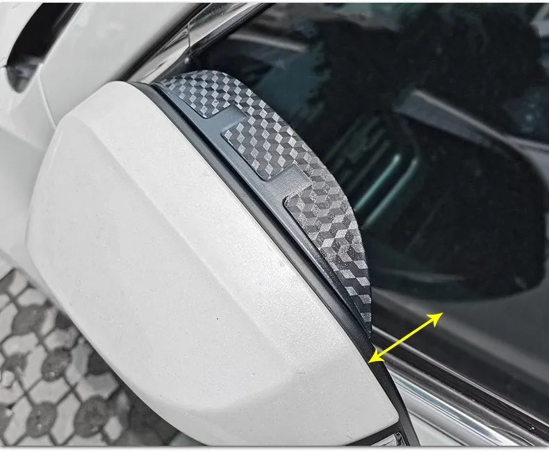Pair of Mazda reversing mirror rain barrier strips in carbon fibre pattern on a Mazda CX5 side mirror