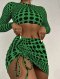 Green and yellow polka dot women's three-piece swimsuit set with bra, bikini top, and skirt.