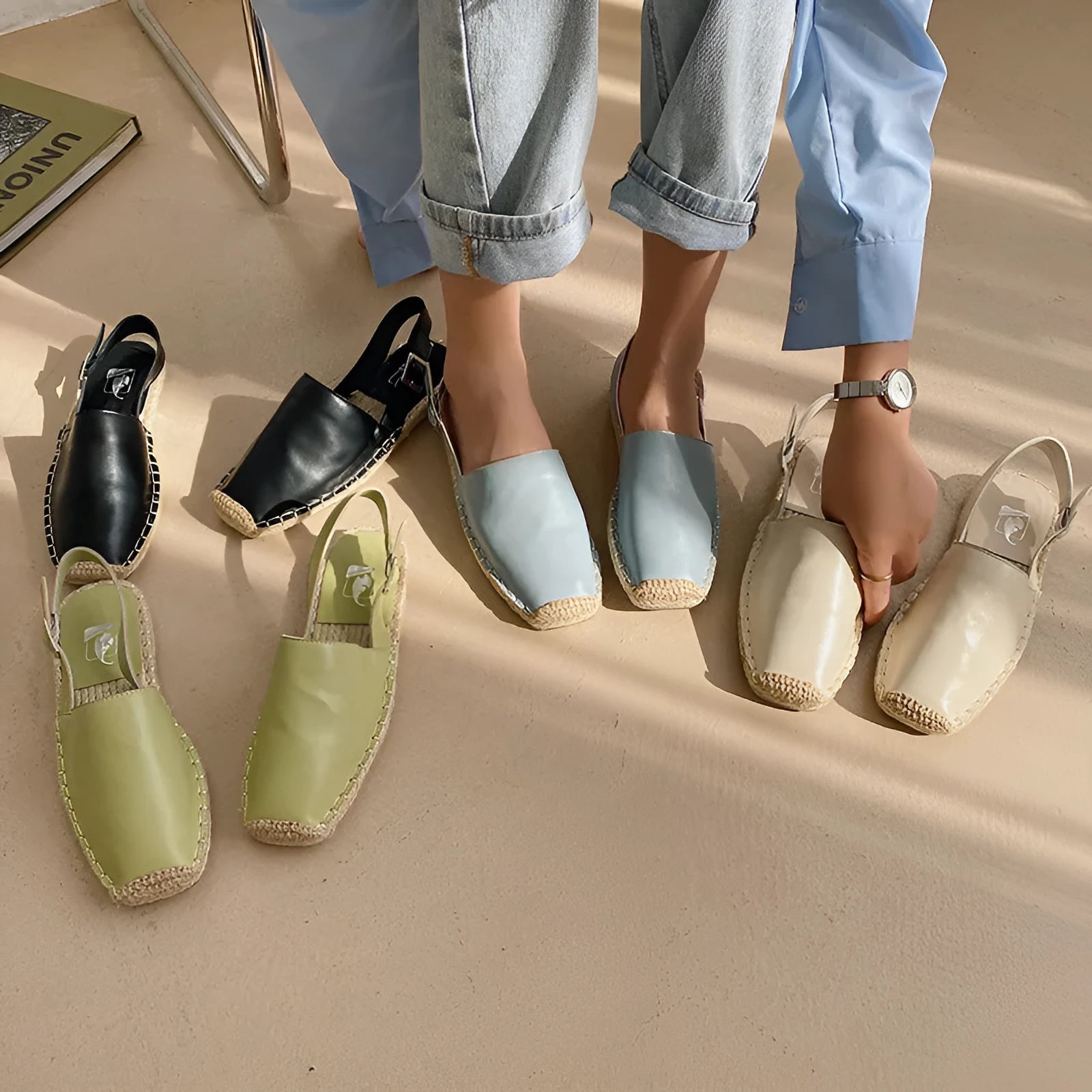 Women's flat sandals in canvas with animal print, showing yellow, black, light blue, and beige colour options.