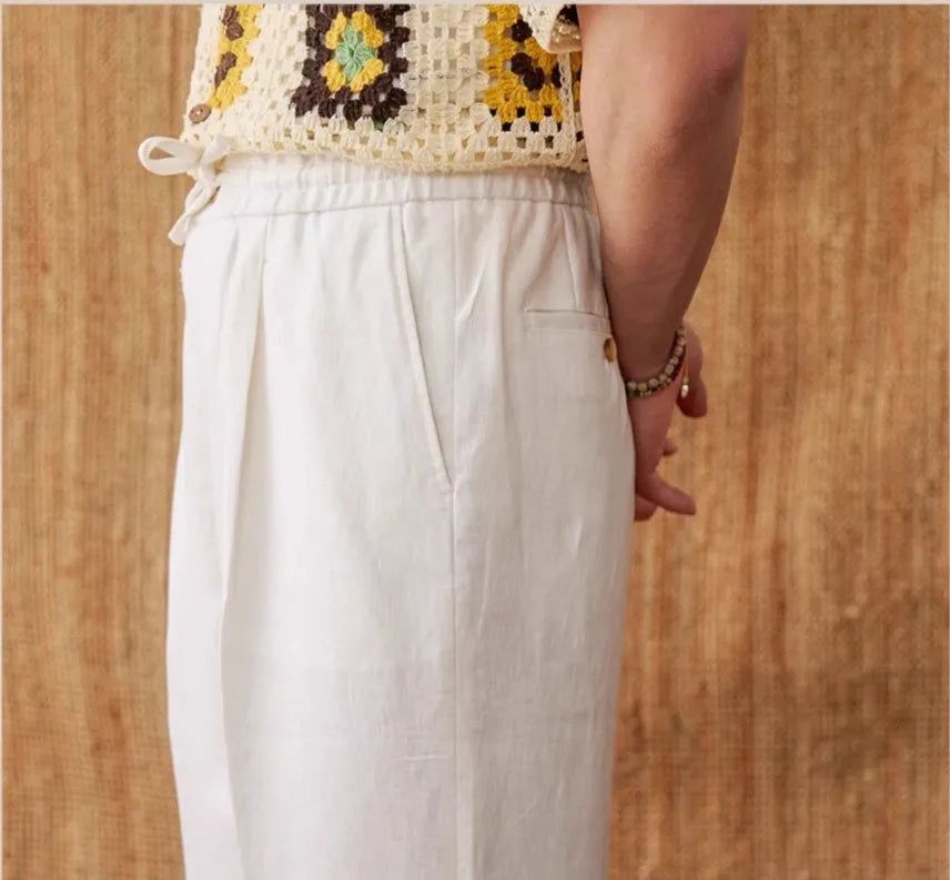 Navy blue linen straight-leg trousers with a high elasticated lace waistband on a hanger.