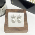 Pearl flower small fragrance earrings in gold and silver with faux pearl centres on alloy metal posts