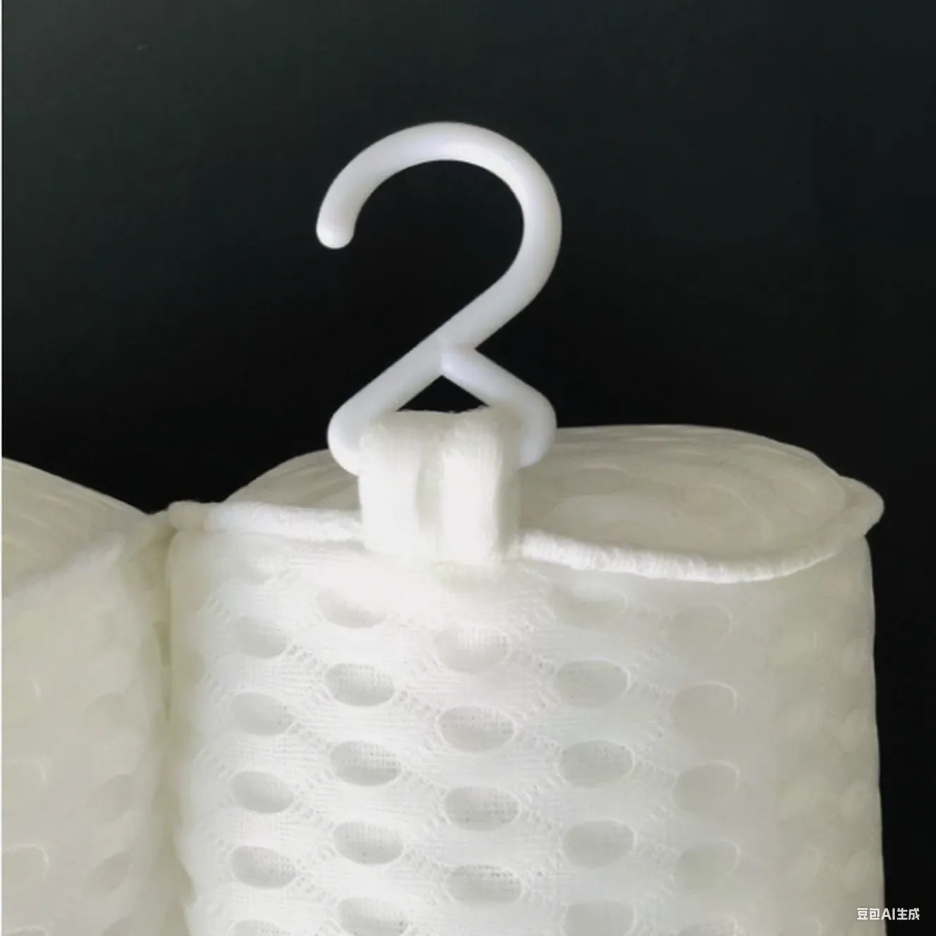 White 4D mesh bathtub pillow with suction cups on a clean bathtub surface.