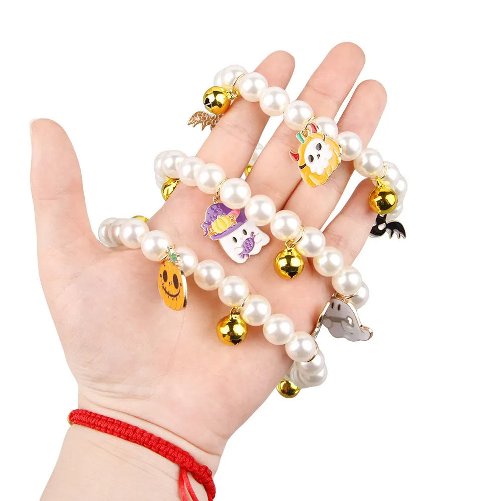 Halloween cat collar with simulated pearls and pumpkin designs including purple ghost, skull, and smiling pumpkin patterns