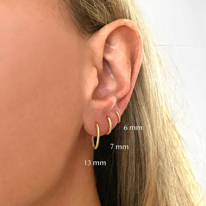 S925 sterling silver twisted string round ring stud earrings in gold and white gold finishes.