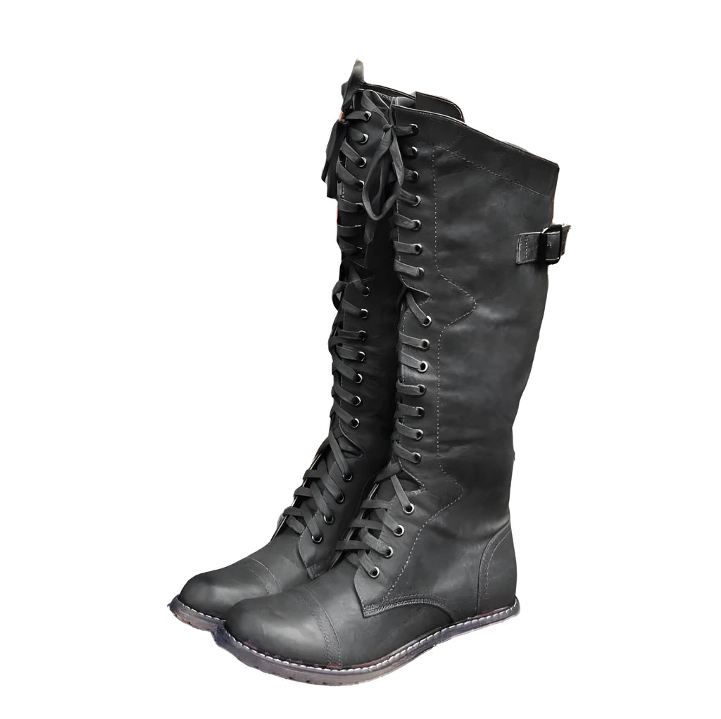 Women's black knight boots with cross-strap design across ankle, mid heel