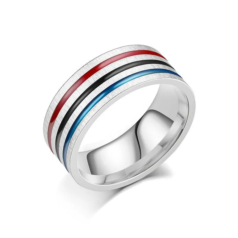 Silver titanium steel ring with rainbow drops of oil pattern and flower shape on white background