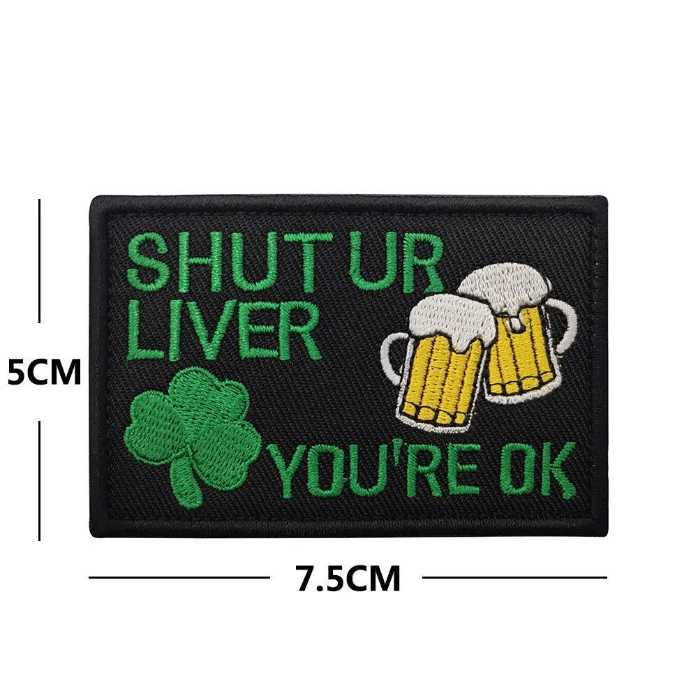Embroidered green clover design Velcro fabric badge patch on a hook and loop strip.