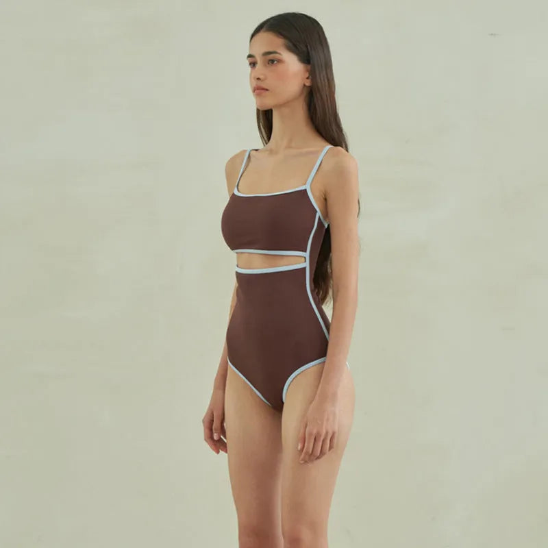 Brown triangle one-piece swimsuit for women on a hanger, showing sexy style and nylon fabric.