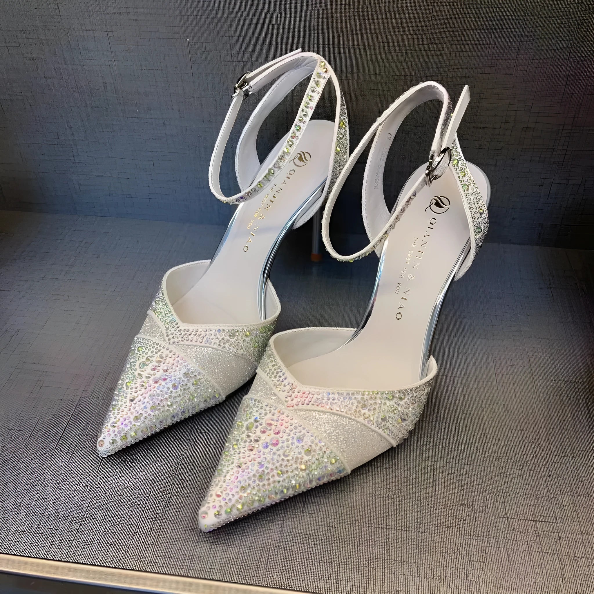 Women's black high heels with hollow stiletto heel, pointed toe, and a bright red sole.