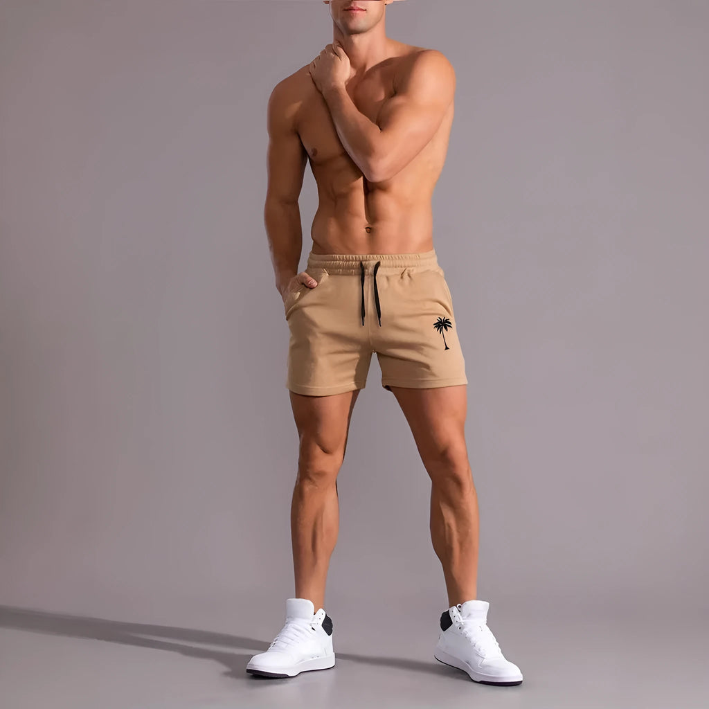 Men's khaki sports shorts with a coconut leaf pattern, showing a straight-leg fit and elasticated waistband.