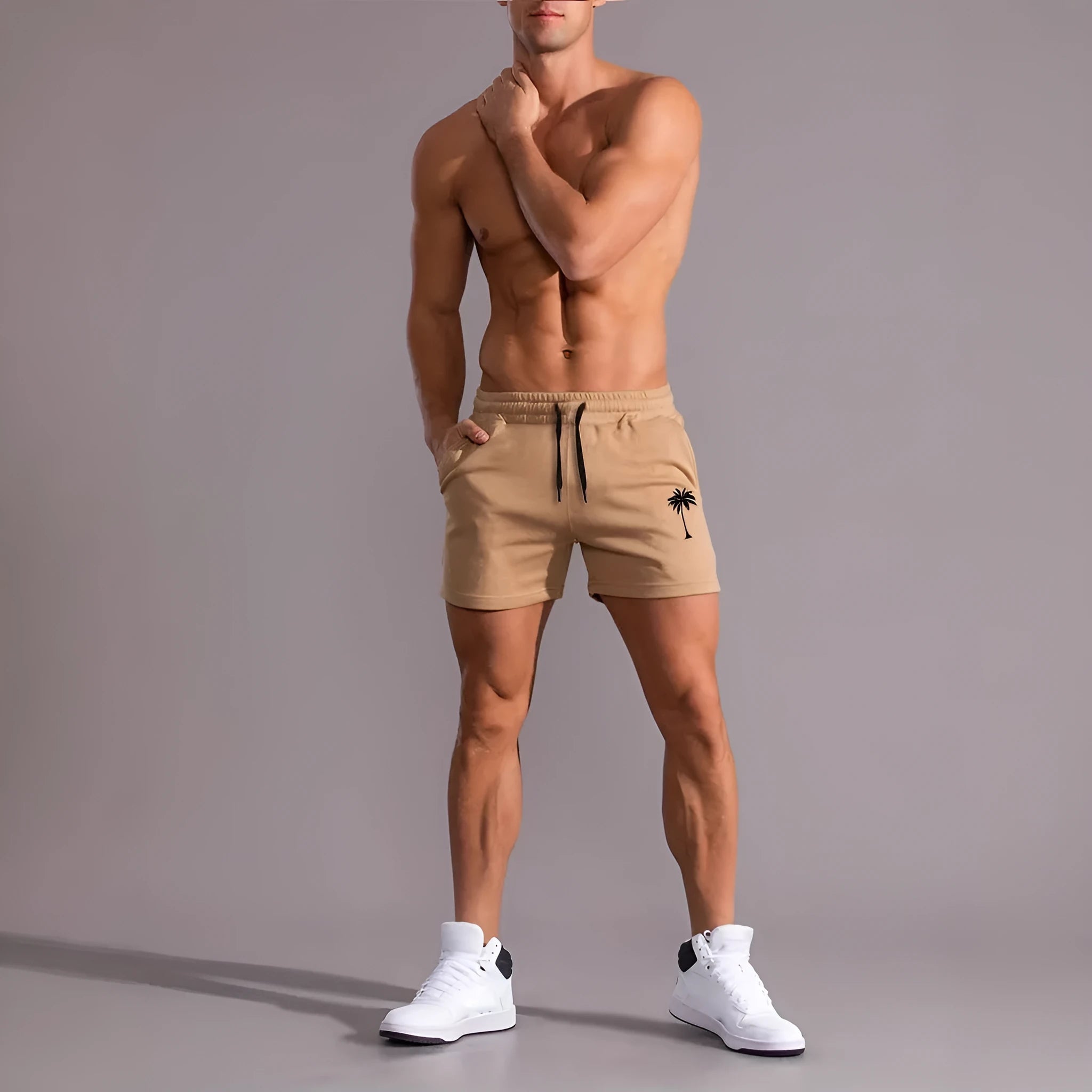 Men's khaki sports shorts with a coconut leaf pattern, showing a straight-leg fit and elasticated waistband.