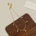 Zircon jewellery set with geometric necklace, matching earrings, and anklet featuring meteor shower design