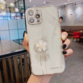 Silicone iPhone case with a spinning 3D flower stand on the back in rose gold colour