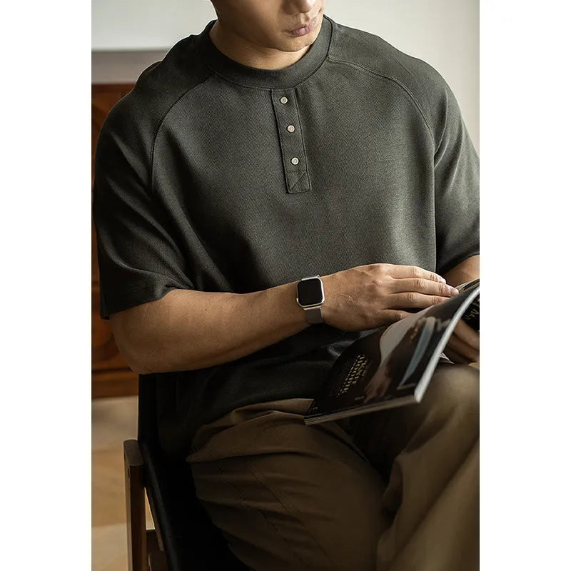 Casual loose-fitting pullover top with raglan sleeves in terry texture fabric shown in smoky grey colour