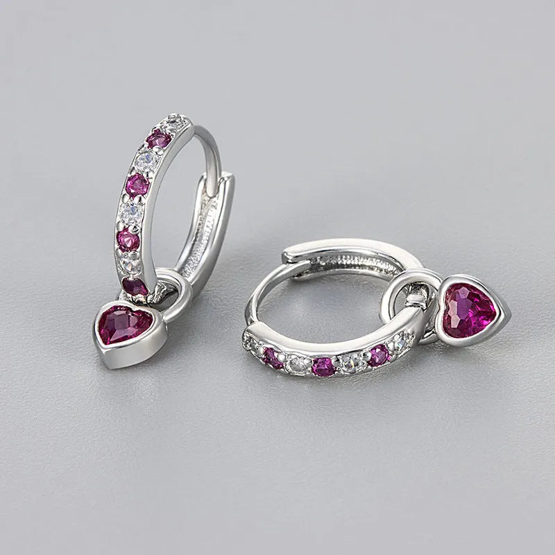 Heart-shaped ladies fashion earrings with coloured stone centrepiece and gold colour plating